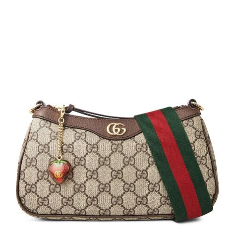 gucci bag with strawberry charm.